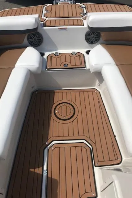 Slide: The Image of 2024 Starcraft SVX 211 boat interior with teak flooring and white cushioned seating. - 10
