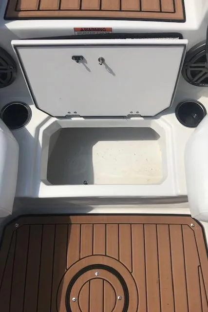 Slide: The Image of 2024 Starcraft SVX 211 boat storage compartment with teak flooring. - 15