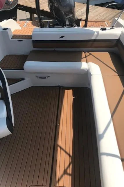 Slide: The Image of 2024 Starcraft SVX 211 boat interior with brown and white seating. - 9