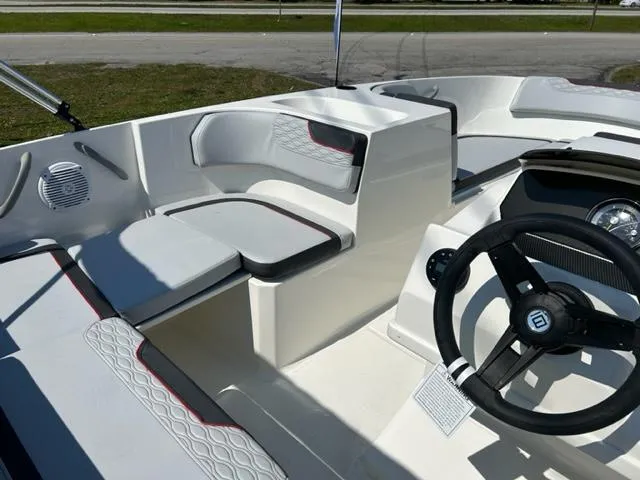 Slide: The Image of 2024 Bayliner Element M17 boat interior with seating and steering wheel. - 10