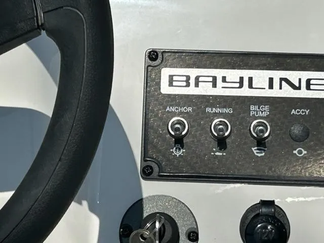 Slide: The Image of Close-up of 2024 Bayliner Element M17 boat control panel and steering wheel. - 11