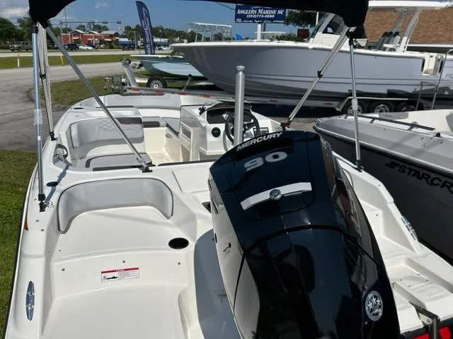 Slide: The Image of 2024 Bayliner Element M17 boat with Mercury 90 engine, displayed at a marina. - 7