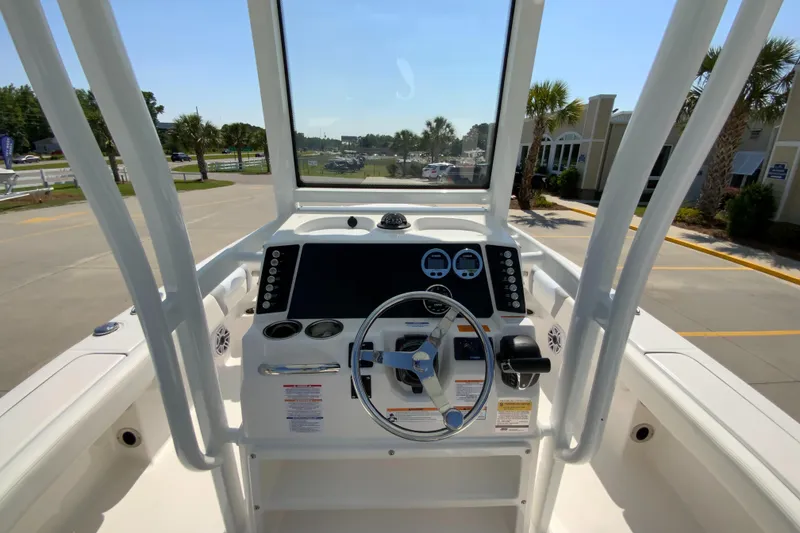Slide: The Image of 2024 Robalo 246 Cayman boat helm with steering wheel and dashboard. - 12