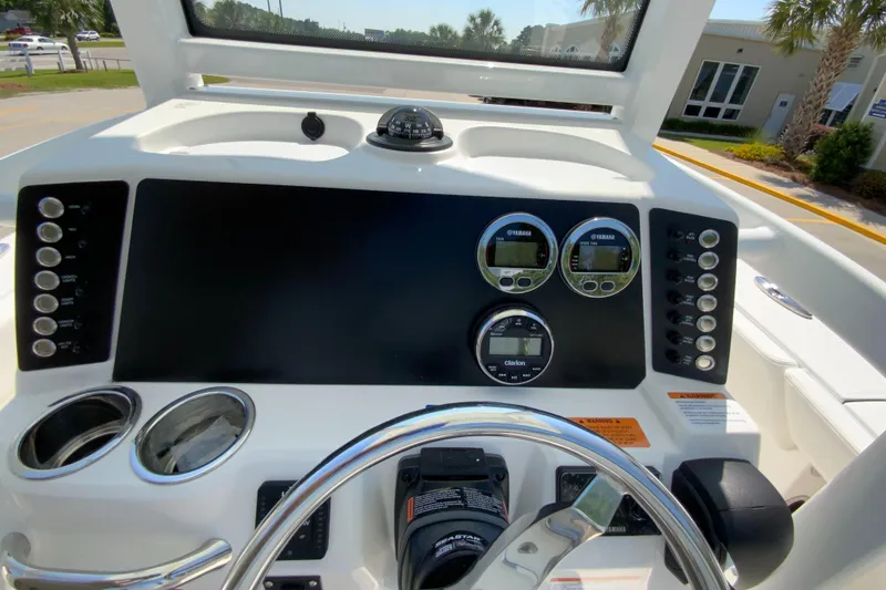 Slide: The Image of 2024 Robalo 246 Cayman boat dashboard with gauges and controls. - 14