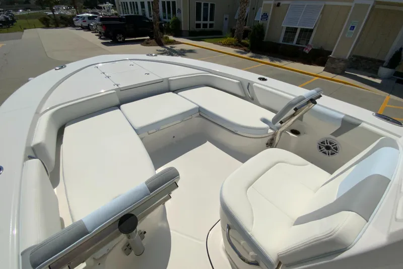 Slide: The Image of 2024 Robalo 246 Cayman boat interior with white seating and steering console. - 18