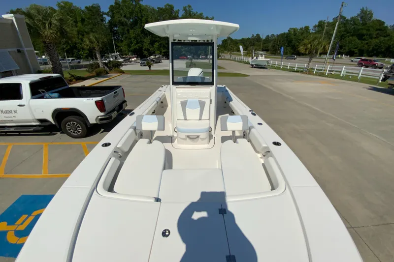 Slide: The Image of 2024 Robalo 246 Cayman boat, front deck view in a parking lot. - 19