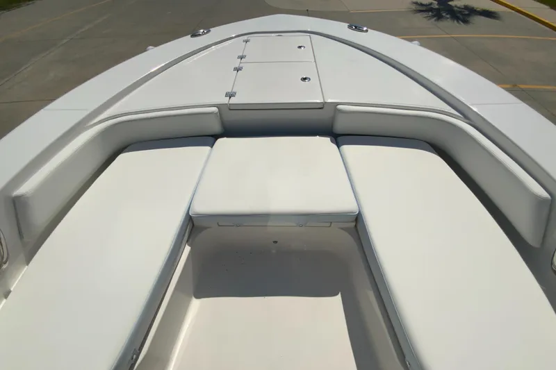 Slide: The Image of 2024 Robalo 246 Cayman boat bow seating area with storage compartments. - 21