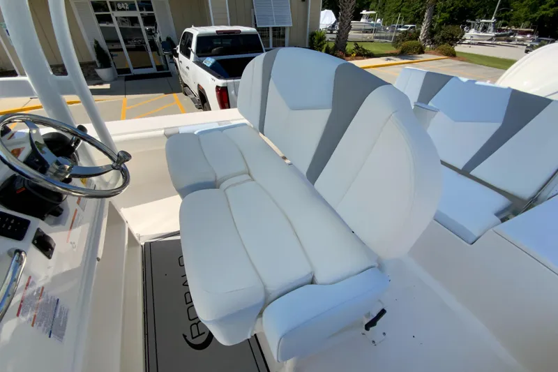 Slide: The Image of 2024 Robalo 246 Cayman boat with white and gray cushioned seating. - 15