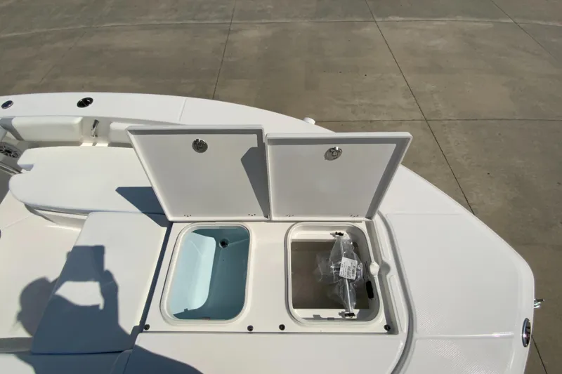 Slide: The Image of 2024 Robalo 246 Cayman boat with open storage compartments. - 20