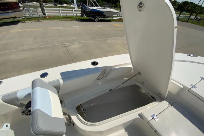 Slide: The Image of 2024 Robalo 246 Cayman boat with open storage compartment. - 23