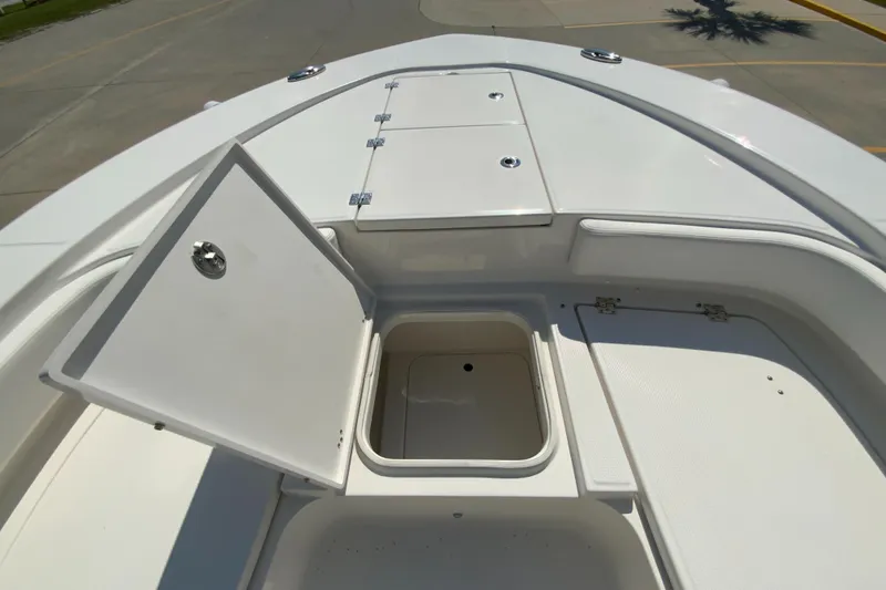 Slide: The Image of 2024 Robalo 246 Cayman boat storage compartments and deck. - 24