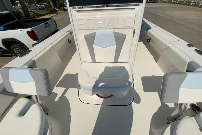 Slide: The Image of 2024 Robalo 246 Cayman boat interior with white and gray seating. - 26