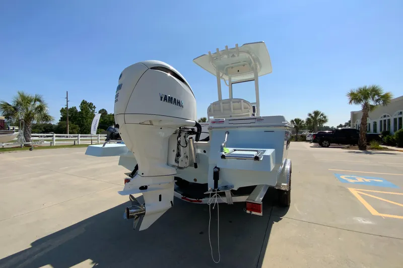 Slide: The Image of 2024 Robalo 246 Cayman boat with Yamaha outboard motor, rear view in parking lot. - 5