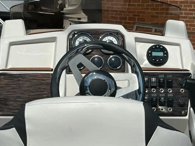 Slide: The Image of 2024 Starcraft SVX 191 boat dashboard with steering wheel and control panel. - 10