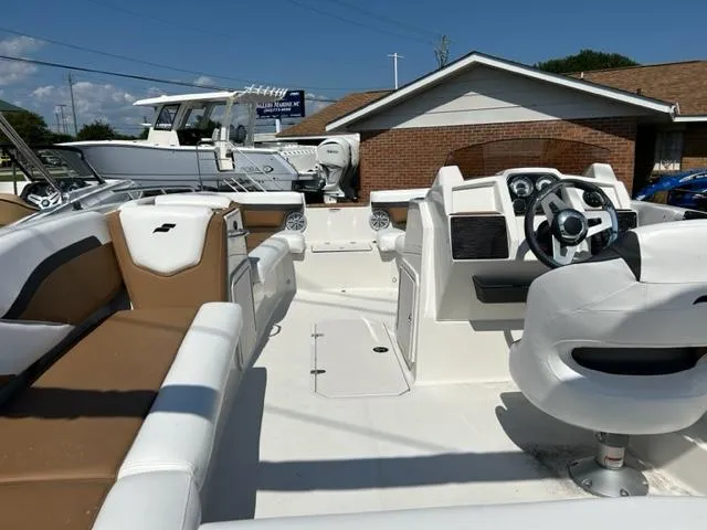Slide: The Image of 2024 Starcraft SVX 191 boat interior with white and tan seating, steering console, and modern controls. - 9