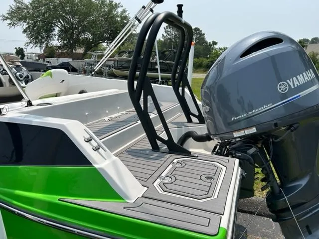 Slide: The Image of 2024 Starcraft SVX 211 Lime Green Sport boat with Yamaha outboard motor. - 3