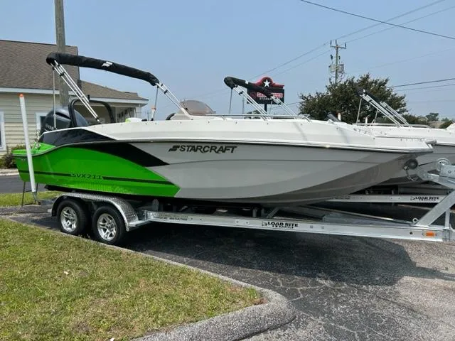 Slide: The Image of 2024 Starcraft SVX 211 Lime Green Sport boat on a trailer. - 0