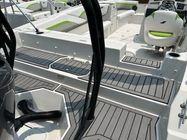 Slide: The Image of 2024 Starcraft SVX 211 Lime Green Sport boat interior with seating and deck. - 12