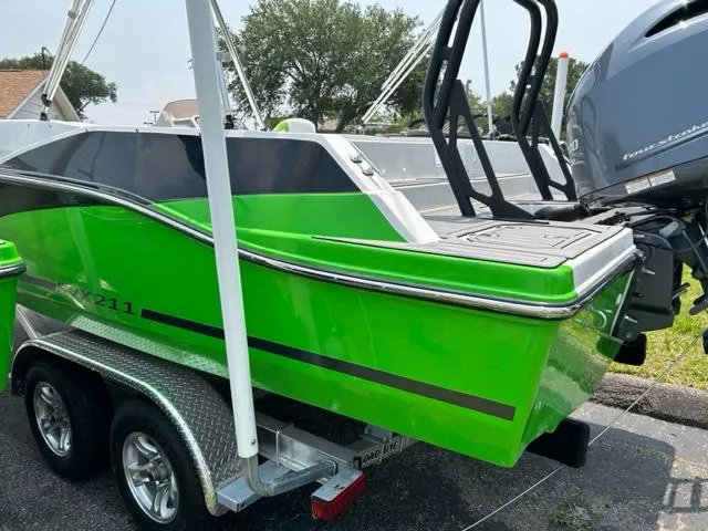 Slide: The Image of 2024 Starcraft SVX 211 Lime Green Sport boat on a trailer. - 2