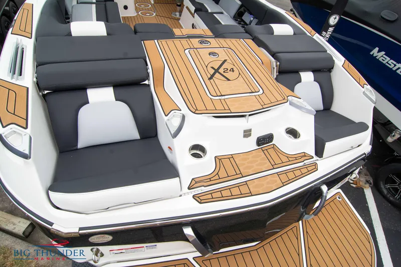 Slide: The Image of 2023 MasterCraft X24 boat with luxurious seating and teak flooring. - 11