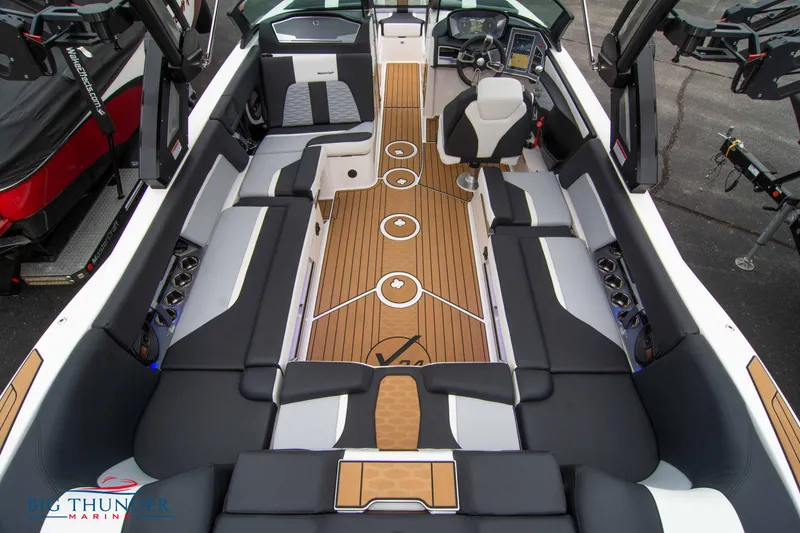 Slide: The Image of 2023 MasterCraft X24 boat interior with luxurious seating and teak flooring. - 15
