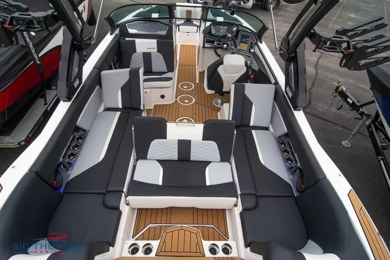 Slide: The Image of 2023 MasterCraft X24 boat interior with luxurious seating and modern dashboard. - 16