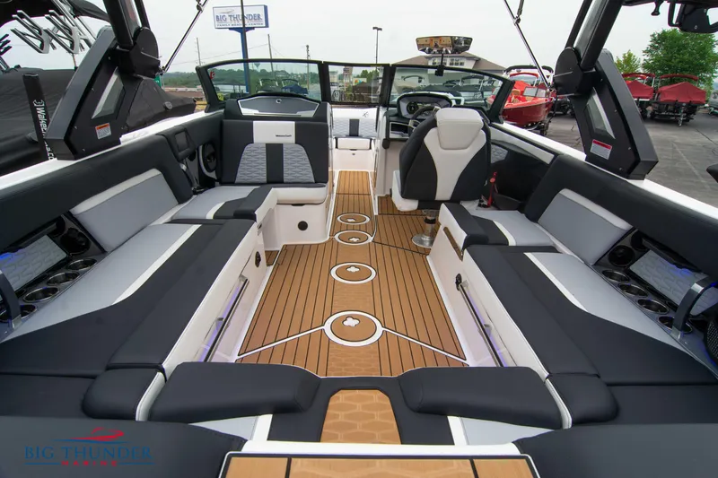 Slide: The Image of 2023 MasterCraft X24 boat interior with luxurious seating and teak flooring. - 17