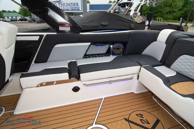 Slide: The Image of 2023 MasterCraft X24 boat interior with luxurious seating and teak flooring. - 18
