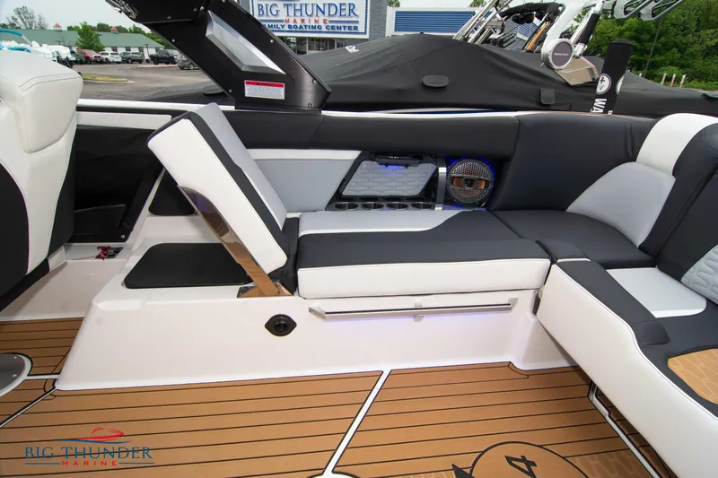 Slide: The Image of 2023 MasterCraft X24 boat interior with luxurious seating and teak flooring. - 19