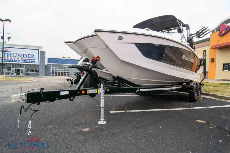 Slide: The Image of 2023 MasterCraft X24 boat on trailer in parking lot. - 3