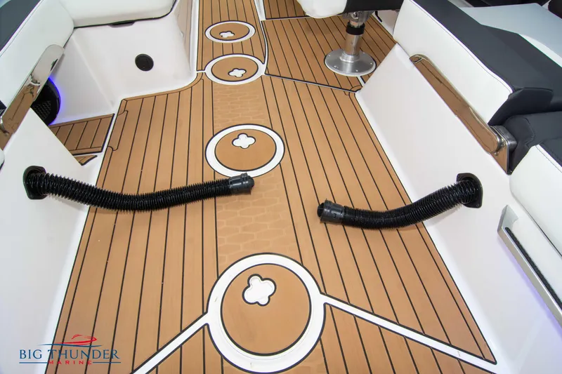 Slide: The Image of 2023 MasterCraft X24 boat interior with teak flooring and seating. - 35
