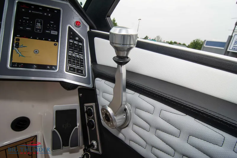 Slide: The Image of 2023 MasterCraft X24 boat interior dashboard and control lever. - 42