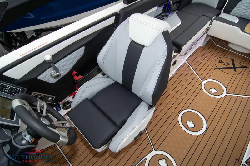 Slide: The Image of 2023 MasterCraft X24 boat interior with captain's chair and teak flooring. - 44