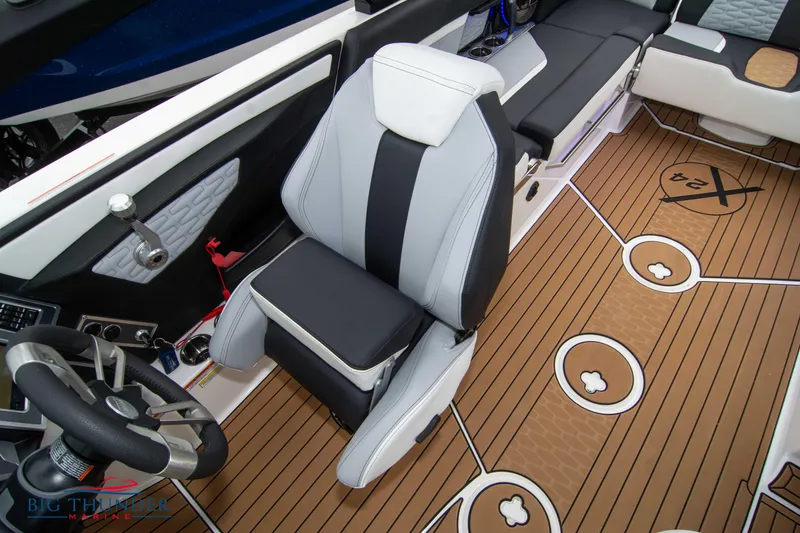 Slide: The Image of 2023 MasterCraft X24 boat interior with captain's chair and teak flooring. - 45