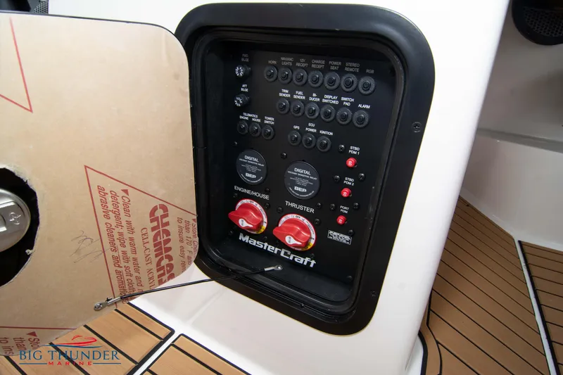 Slide: The Image of Control panel of a 2023 MasterCraft X24 boat with switches and dials. - 49
