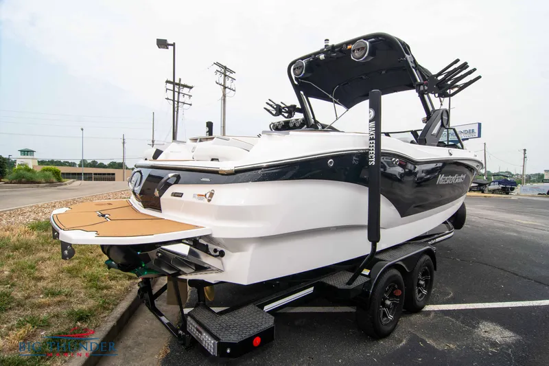 Slide: The Image of 2023 MasterCraft X24 boat on a trailer in a parking lot. - 5