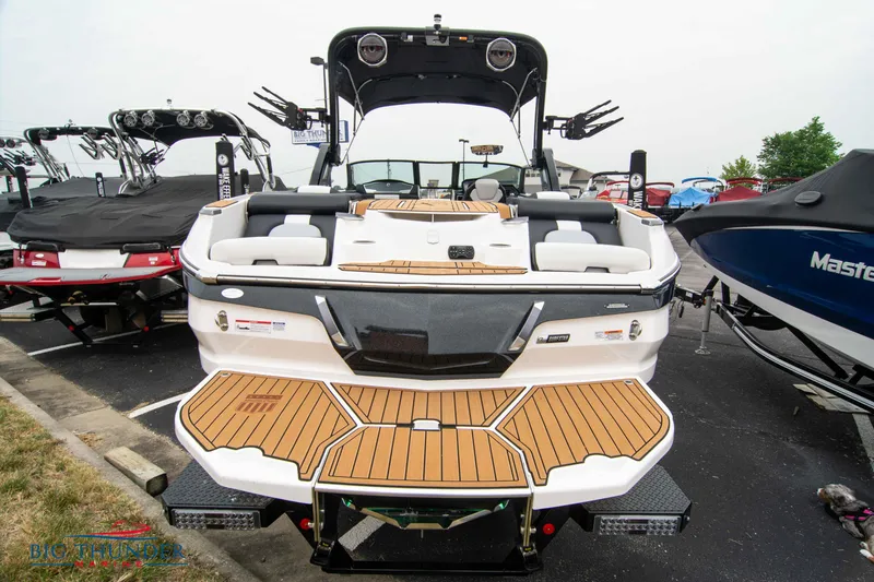 Slide: The Image of 2023 MasterCraft X24 boat with teak deck, rear view in a marina. - 6