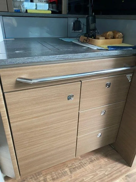 Slide: The Image of 2017 Formula 430 Super Sport Crossover kitchen area with wooden cabinets and countertop. - 12