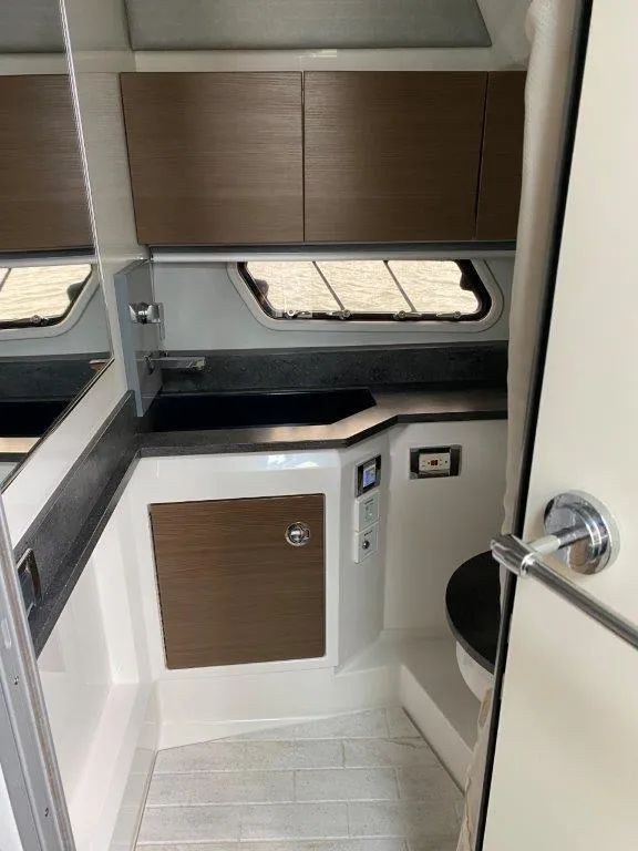 Slide: The Image of 2017 Formula 430 Super Sport Crossover bathroom with modern cabinetry and fixtures. - 14