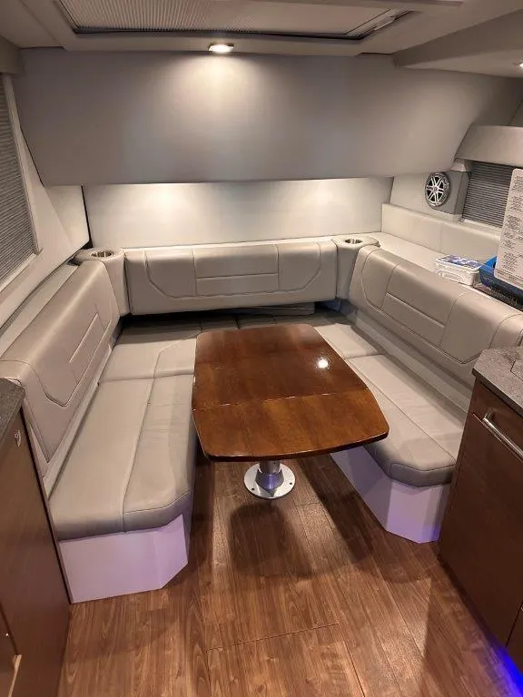 Slide: The Image of 2017 Formula 430 Super Sport Crossover interior with U-shaped seating and wooden table. - 15