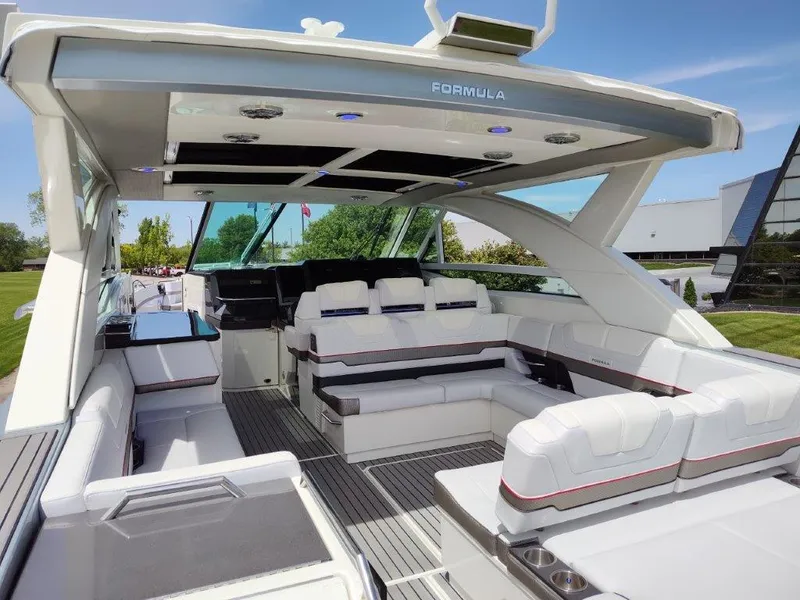 Slide: The Image of 2017 Formula 430 Super Sport Crossover luxury yacht interior with white seating and modern design. - 18