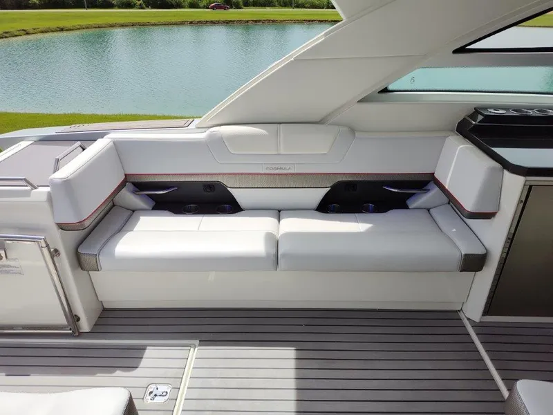 Slide: The Image of 2017 Formula 430 Super Sport Crossover boat interior seating by the water. - 22