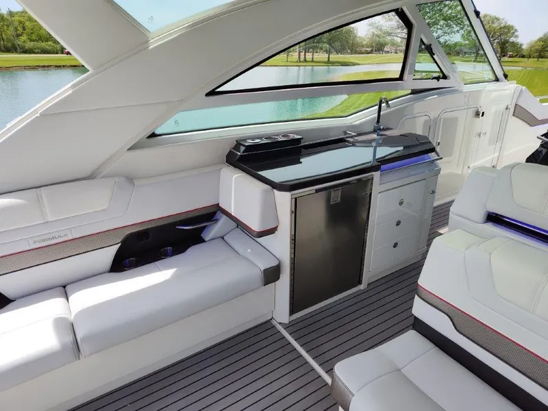 Slide: The Image of Interior of a 2017 Formula 430 Super Sport Crossover yacht with modern seating and kitchenette. - 23