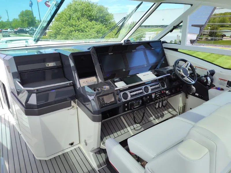 Slide: The Image of Cockpit of a 2017 Formula 430 Super Sport Crossover boat with advanced navigation systems. - 26