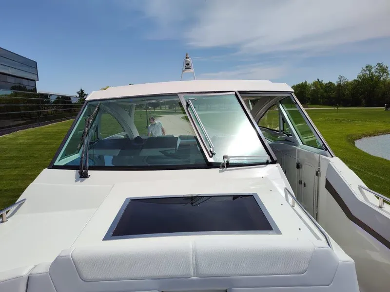 Slide: The Image of 2017 Formula 430 Super Sport Crossover boat, front view with windshield and open cabin door. - 35