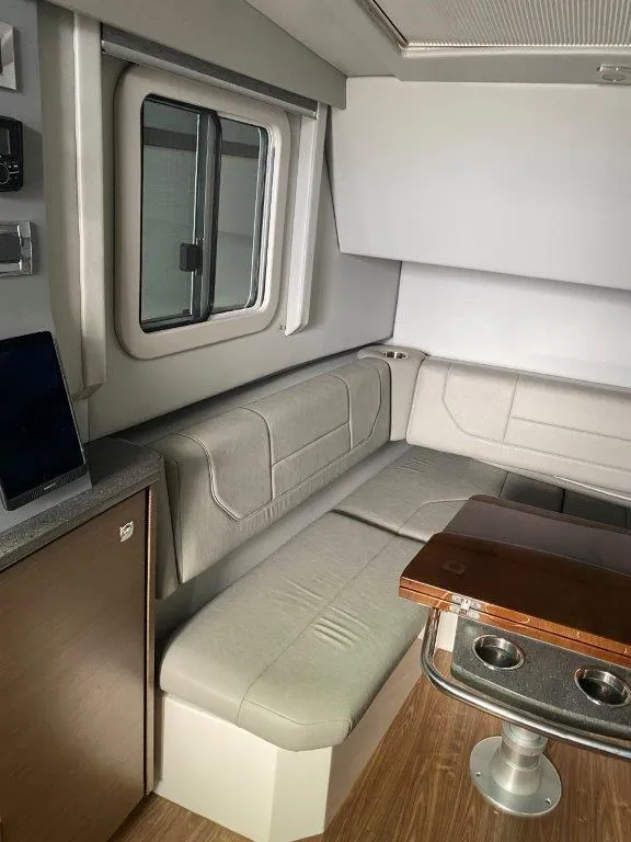 Slide: The Image of Interior of a 2017 Formula 430 Super Sport Crossover with seating and table. - 9