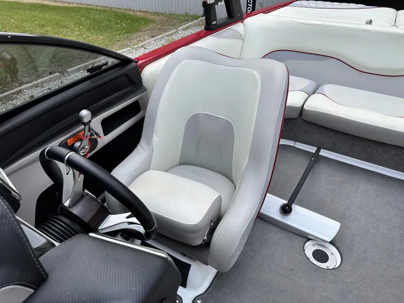 Slide: The Image of Interior of a 2014 Malibu VTX Wakesetter boat with white and gray seating. - 10