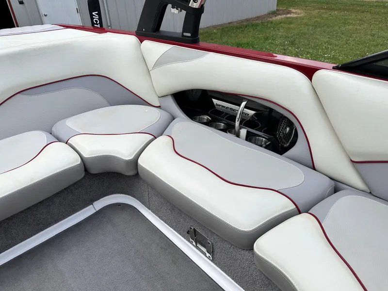 Slide: The Image of 2014 Malibu VTX Wakesetter boat interior with white and red cushioned seating. - 11
