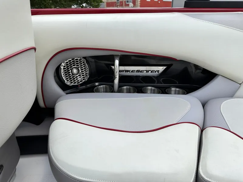 Slide: The Image of 2014 Malibu VTX WAKESETTER boat interior with speaker and cup holders. - 12