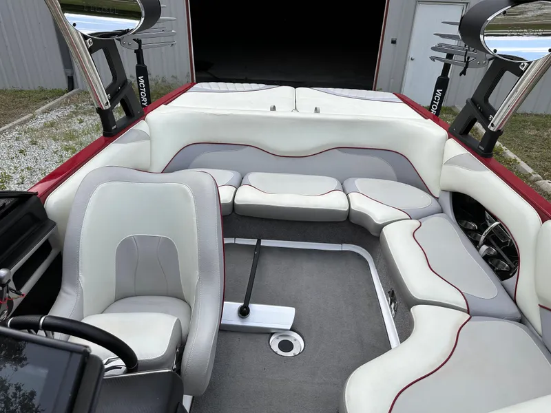 Slide: The Image of 2014 Malibu VTX Wakesetter boat interior with white and gray seating. - 9